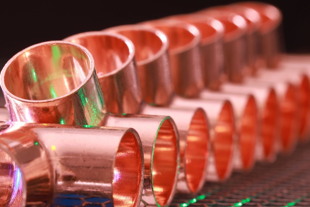 Licensed stock photograph: a row of copper plumbing fittings.